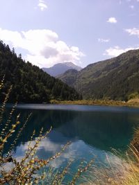Scenic view of lake against cloudy sky