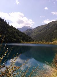 Scenic view of lake against cloudy sky