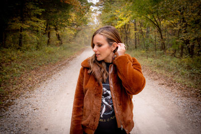 Young woman standing in forest