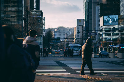People crossing road in city