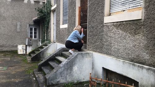 Man sitting on staircase of building