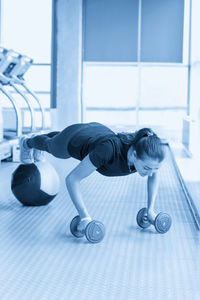 Rear view of man exercising in gym