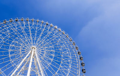 Low angle view of ferris wheel against sky