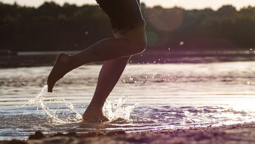 Low section of woman in water