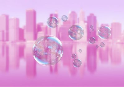 Digital composite image of bubbles against financial district by river