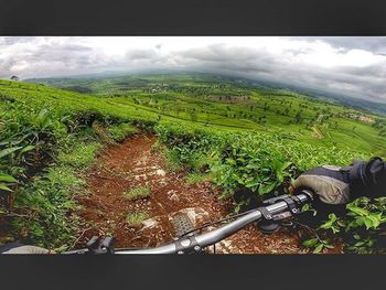 Scenic view of field against cloudy sky