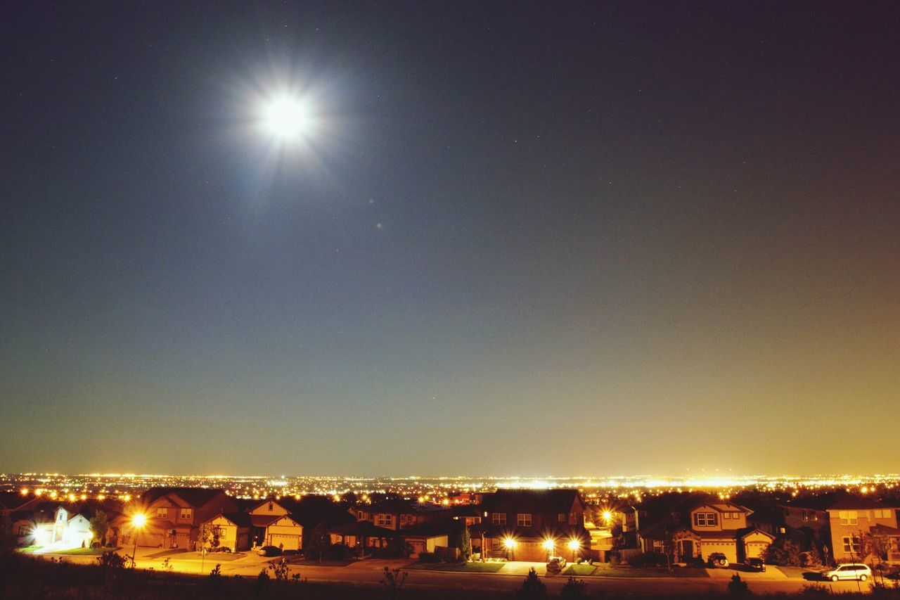 illuminated, night, building exterior, architecture, cityscape, built structure, city, copy space, clear sky, moon, residential district, residential building, residential structure, crowded, high angle view, sky, city life, outdoors, house, no people