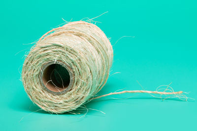 Close-up of rope over blue background