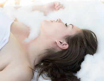 Close-up of female model lying on bed