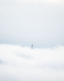 Wind turbine over clouds
