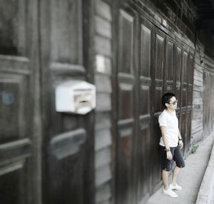 Full length of woman standing on bench