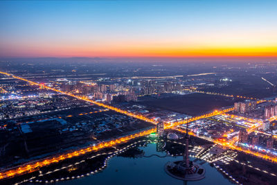 High angle view of illuminated buildings in city at night