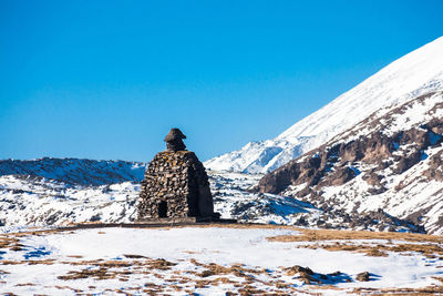 Scenic view of snowcapped mountains against clear blue sky