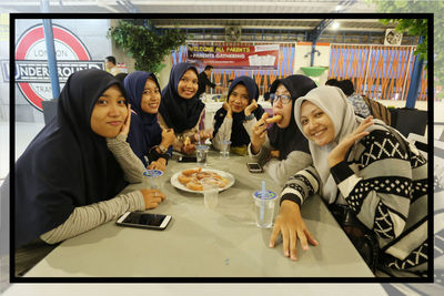 Portrait of people sitting at restaurant table