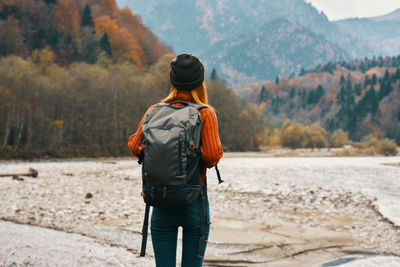 Rear view of man standing on shore