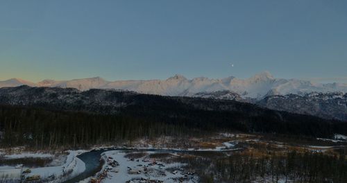 Scenic view of snowcapped mountains against clear sky