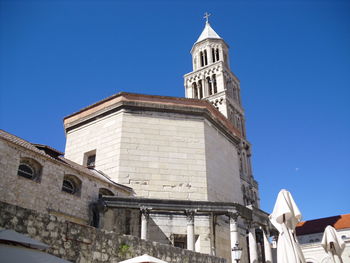 Low angle view of building against clear blue sky