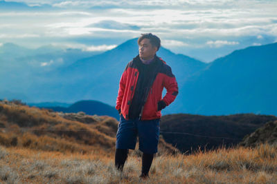 Full length of young man standing on mountain