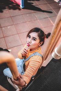 Portrait of young woman eat candy