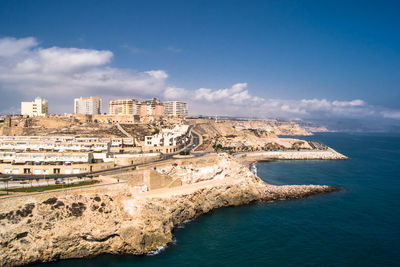 Scenic view of sea and buildings against sky