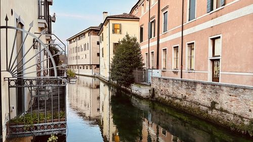 Canal amidst buildings in city