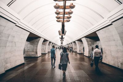 Rear view of people walking in corridor