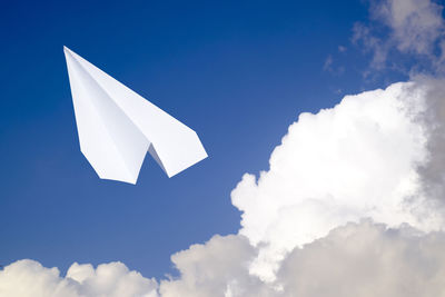 Low angle view of paper flag against blue sky
