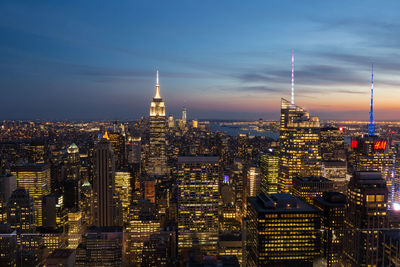 Illuminated cityscape against sky at night