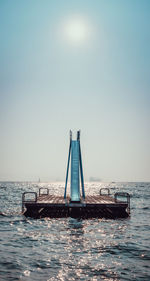 View of floating platform in sea against clear sky