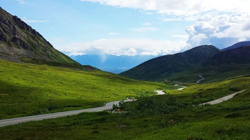 Scenic view of landscape against cloudy sky