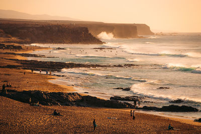 Scenic view of beach against sky during sunset