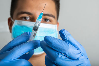 Cropped hand holding syringe
