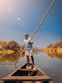 Side view of man standing on boat