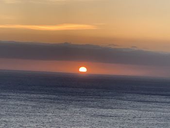 Scenic view of sea against romantic sky at sunset