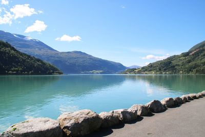 Scenic view of lake and mountains against sky