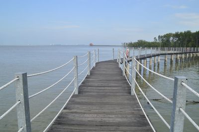 Pier over sea against sky