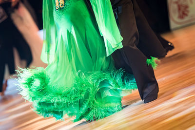 Low section of people dancing on hardwood floor