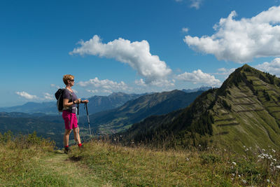 Full length of man standing on mountain against sky