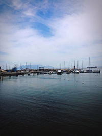 Sailboats in sea against sky