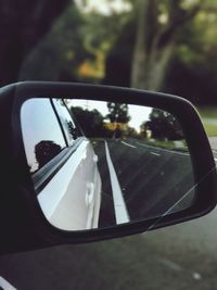 Close-up of side-view mirror of car