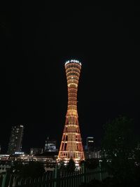 Low angle view of illuminated buildings against sky at night