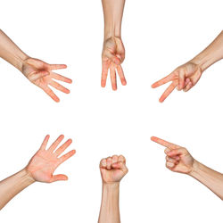 Low angle view of people hands against white background
