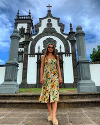 Full length of woman standing against building