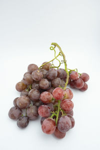Close-up of grapes against white background
