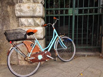 Bicycle parked against brick wall