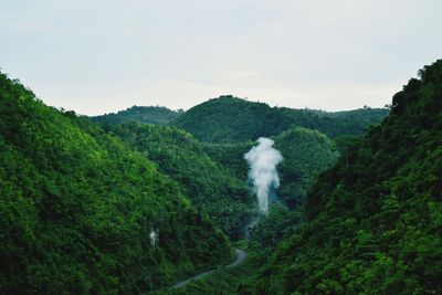 Smoke emitting from volcanic mountain against sky