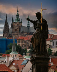 Statue of buildings against sky in city