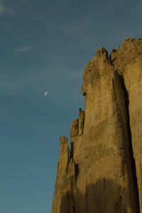 Low angle view of rock formation against sky