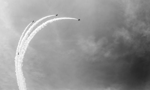 Low angle view of airplane flying against sky airshow