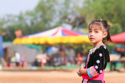 Portrait of cute girl standing outdoors